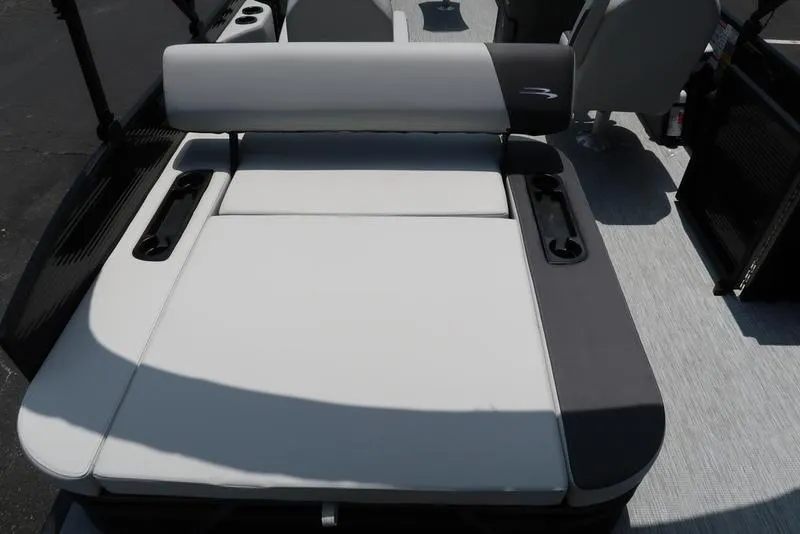 Slide: The Image of 2025 Bennington S Swingback 22 SSB boat interior with cushioned seating and cup holders. - 26
