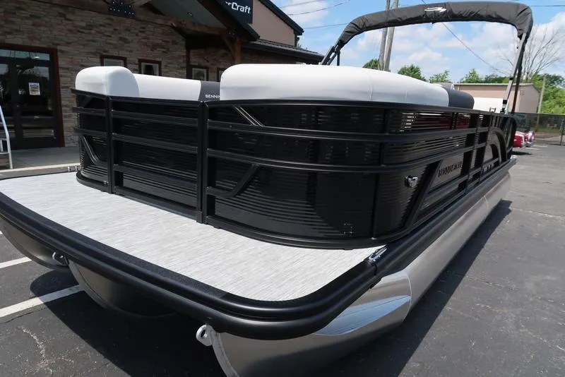 Slide: The Image of 2025 Bennington S Swingback 22 SSB pontoon boat, black exterior, parked outdoors. - 4