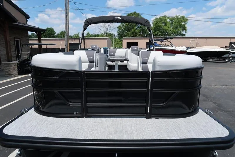 Slide: The Image of 2025 Bennington S Swingback 22 SSB pontoon boat, black exterior, parked outdoors. - 5