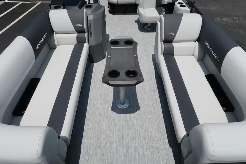 Slide: The Image of 2025 Bennington S Swingback 22 SSB boat interior with gray seating and central table. - 7
