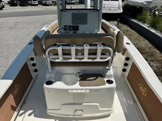Slide: The Image of 2019 NauticStar 251 Hybrid boat interior with rod holders and seating. - 12
