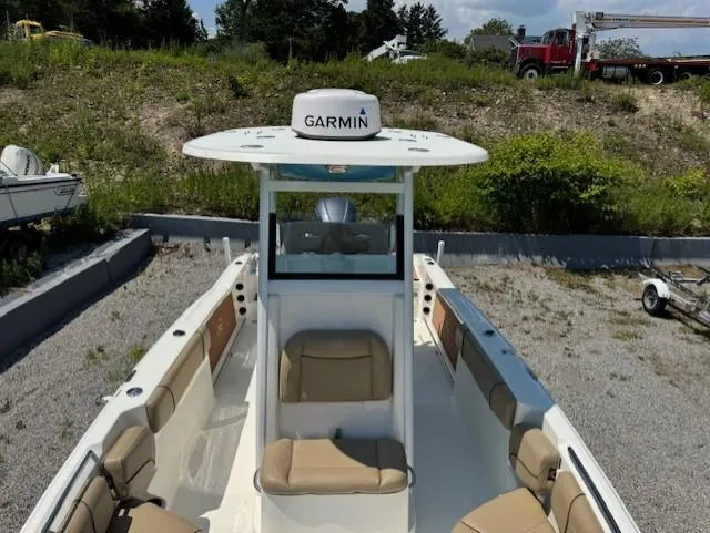 Slide: The Image of 2019 NauticStar 251 Hybrid boat with Garmin equipment, docked on gravel, surrounded by greenery. - 5