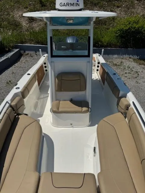 Slide: The Image of 2019 NauticStar 251 Hybrid boat with tan seating and Garmin equipment. - 6