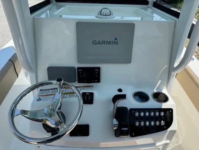 Slide: The Image of 2019 NauticStar 251 Hybrid boat console with Garmin navigation system and steering wheel. - 8