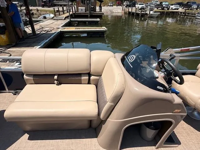 Slide: The Image of 2023 Sun Tracker Fishin' Barge 20 DLX pontoon boat interior with beige seating and helm. - 11