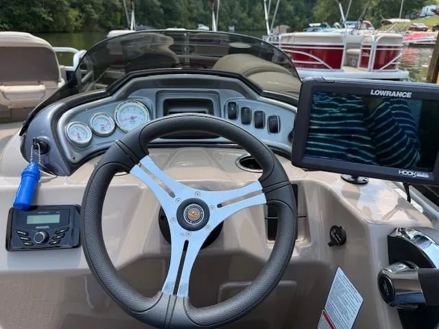 Slide: The Image of 2023 Sun Tracker Fishin' Barge 20 DLX dashboard with steering wheel and navigation system. - 8