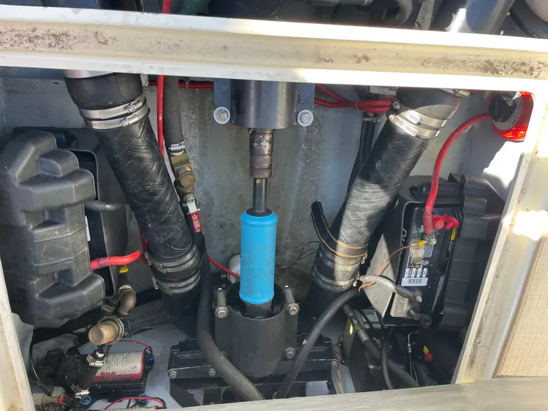 Slide: The Image of Engine compartment of a 1998 Albemarle 247 Cuddy Express boat, showing hoses and battery. - 13