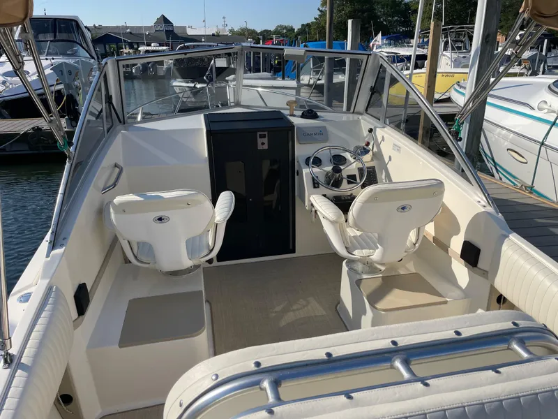 Slide: The Image of 1998 Albemarle 247 Cuddy Express boat named "Boomerang" docked at a marina. - 5