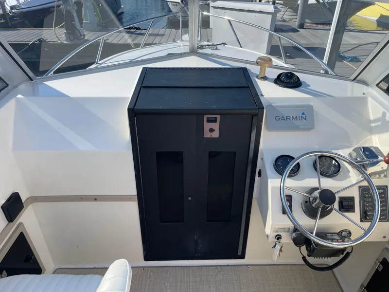Slide: The Image of 1998 Albemarle 247 Cuddy Express helm with Garmin navigation and steering wheel. - 8