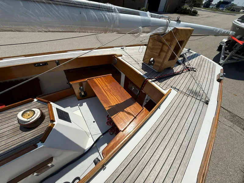 Slide: The Image of 1998 Tofinou 7 sailboat deck with wooden accents and rigging details. - 10