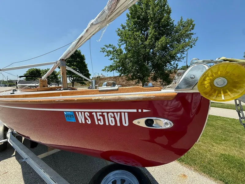 Slide: The Image of Red Tofinou 7 sailboat from 1998 on trailer, sunny day, registration visible. - 11