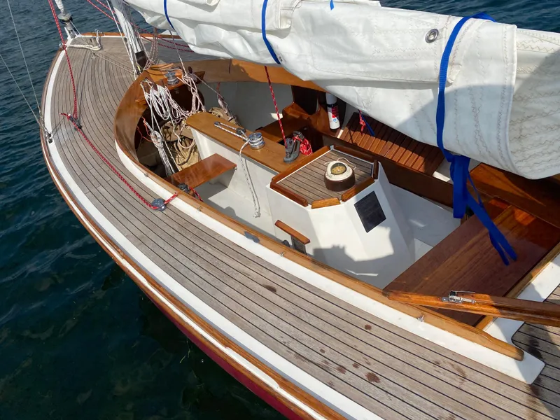 Slide: The Image of Classic 1998 Tofinou 7 sailboat with wooden deck and neatly stowed sails. - 14