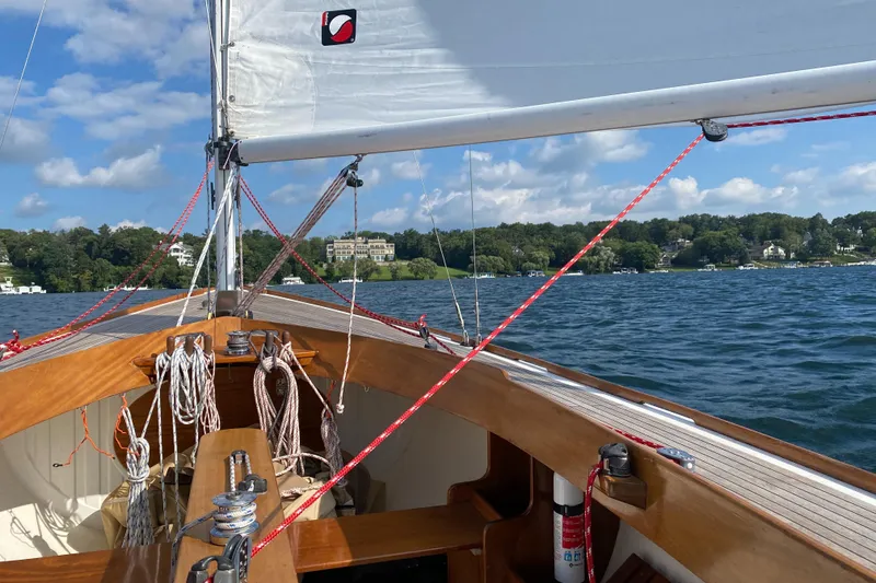 Slide: The Image of Sailing on a 1998 Tofinou 7 yacht, with scenic lake and shoreline views. - 18