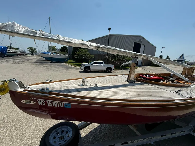 Slide: The Image of 1998 Tofinou 7 sailboat on trailer, parked in marina lot under clear sky. - 8