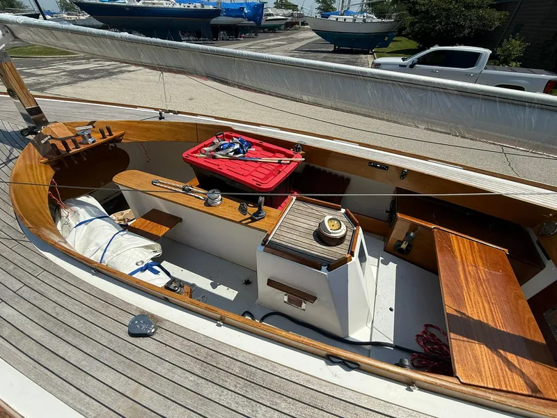 Slide: The Image of 1998 Tofinou 7 sailboat interior with wooden deck and storage compartments. - 9
