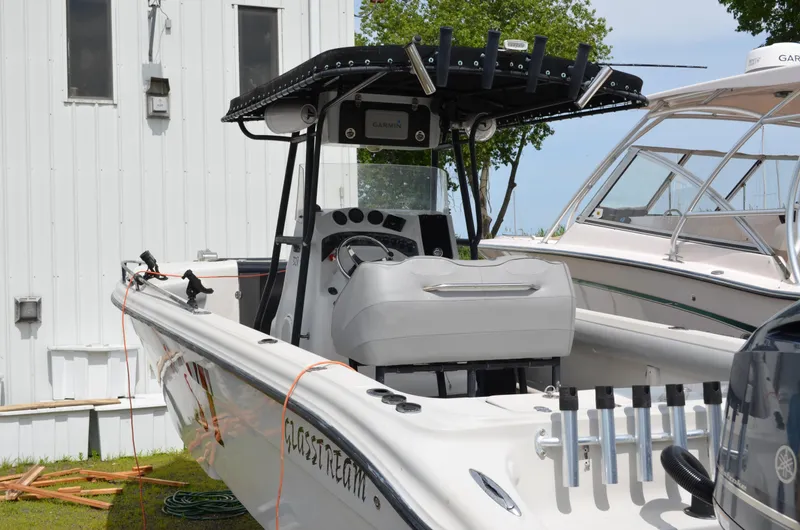 Slide: The Image of 2005 Glasstream 328 SCX boat docked, featuring a sleek design and modern controls. - 12