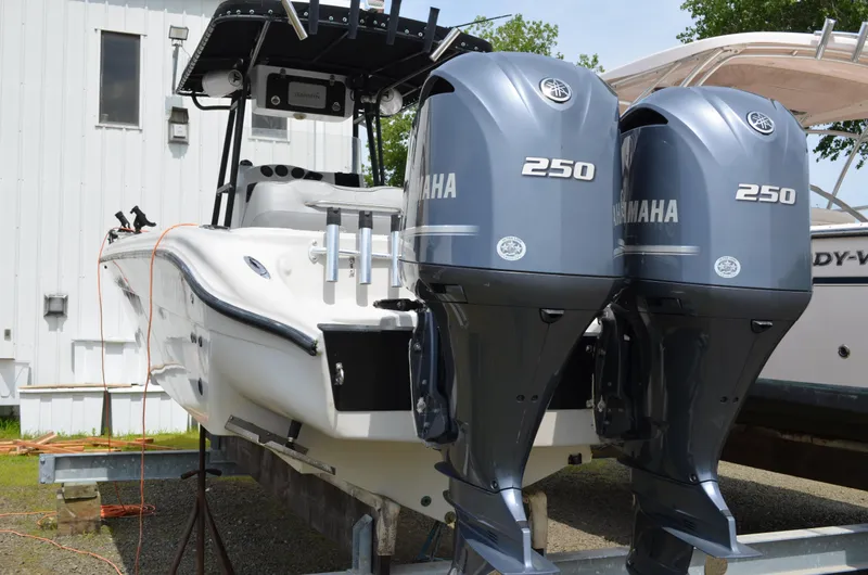Slide: The Image of 2005 Glasstream 328 SCX boat with dual Yamaha 250 engines, docked outdoors. - 13