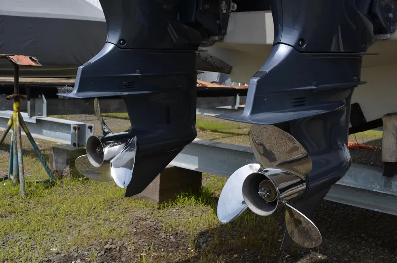 Slide: The Image of Dual outboard motors on a 2005 Glasstream 328 SCX boat, displayed on a trailer. - 15