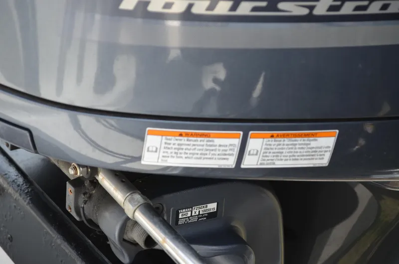 Slide: The Image of Close-up of a 2005 Glasstream 328 SCX boat engine with warning labels. - 18