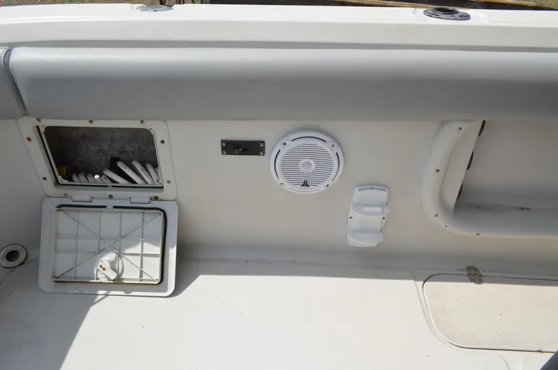 Slide: The Image of Interior view of a 2005 Glasstream 328 SCX boat, featuring storage compartments and speaker. - 20