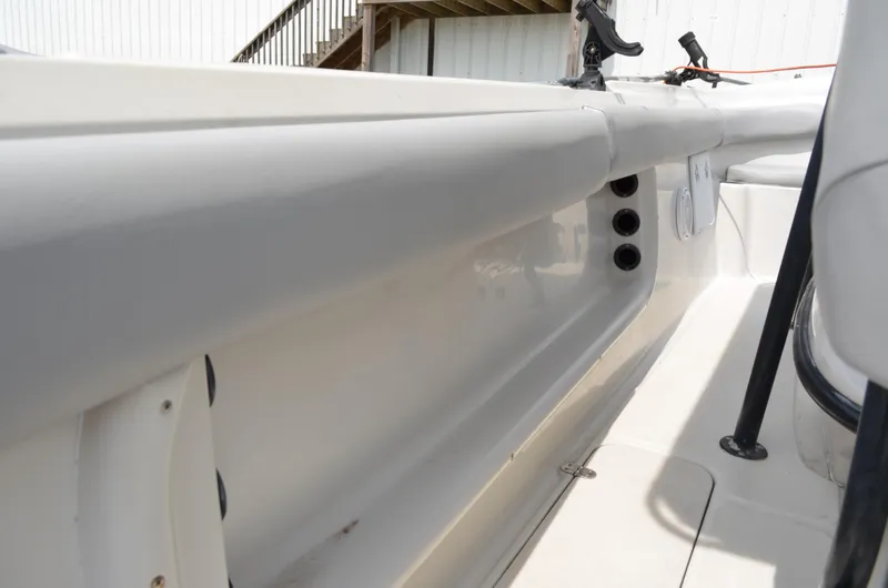 Slide: The Image of 2005 Glasstream 328 SCX boat interior with rod holders and seating area. - 24