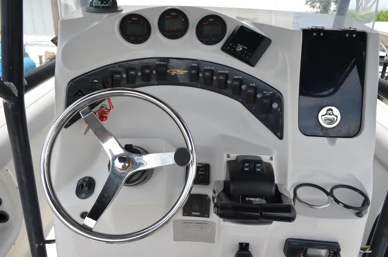 Slide: The Image of 2005 Glasstream 328 SCX boat dashboard with steering wheel and control panel. - 26