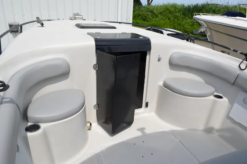 Slide: The Image of 2005 Glasstream 328 SCX boat interior with seating and storage compartment. - 31