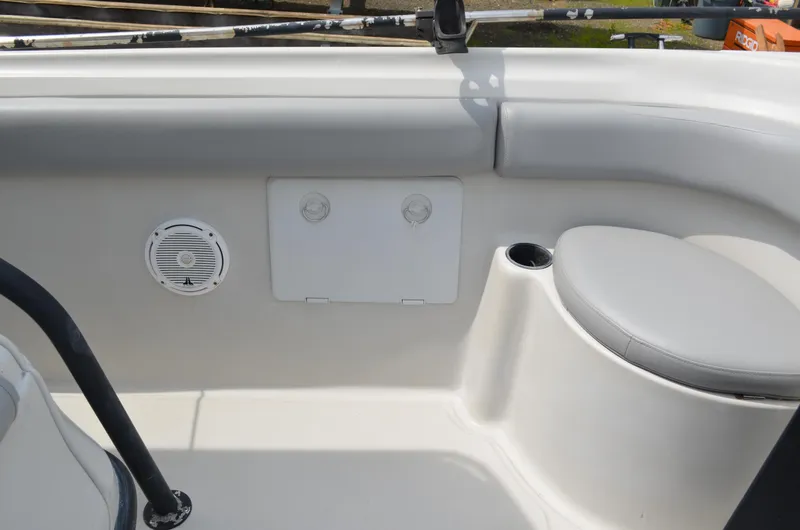 Slide: The Image of 2005 Glasstream 328 SCX boat interior with speaker, seating, and storage compartment. - 34