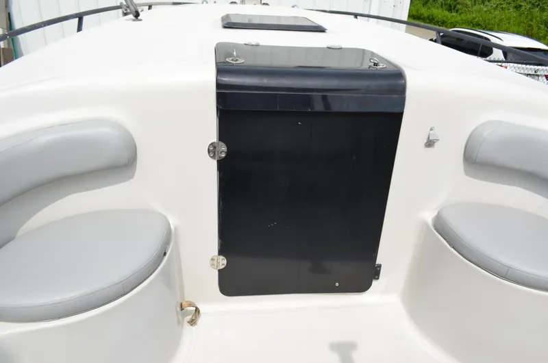 Slide: The Image of 2005 Glasstream 328 SCX boat interior with seating and storage compartment. - 37