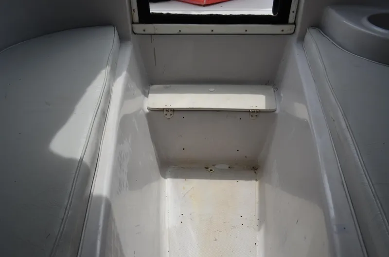 Slide: The Image of Interior view of a 2005 Glasstream 328 SCX boat, featuring seating and storage area. - 42