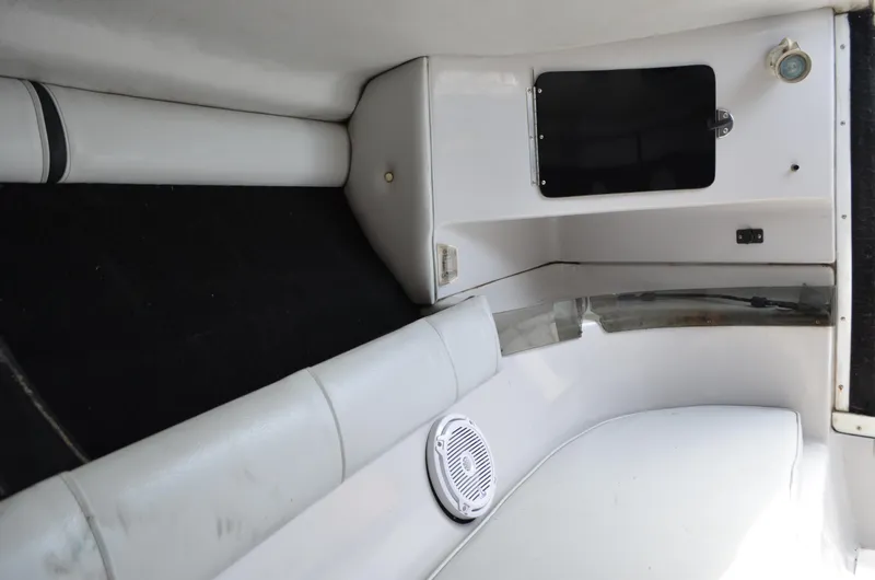 Slide: The Image of Interior of 2005 Glasstream 328 SCX boat, featuring white seating and storage compartments. - 44