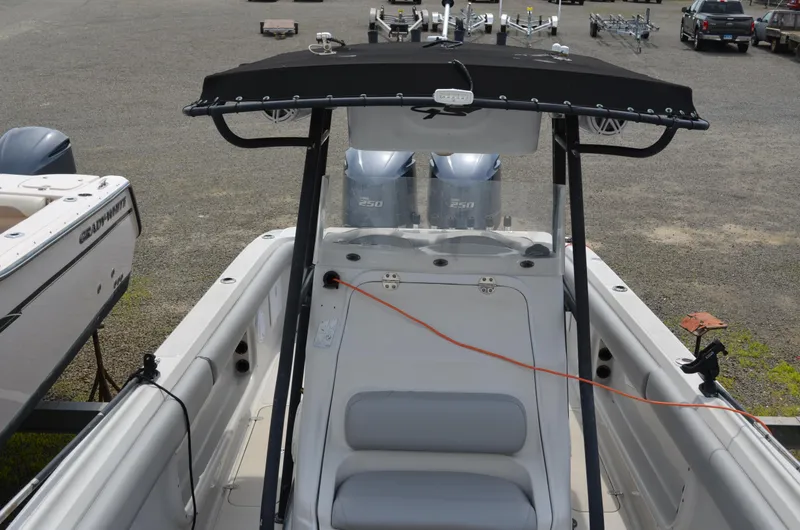 Slide: The Image of 2005 Glasstream 328 SCX boat with dual engines and canopy, parked on gravel. - 46