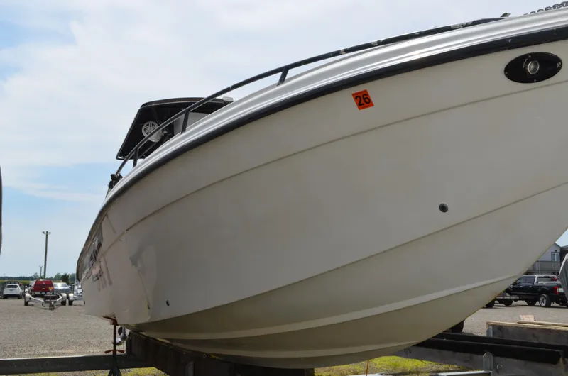 Slide: The Image of 2005 Glasstream 328 SCX boat on trailer, viewed from the front, in a parking area. - 9