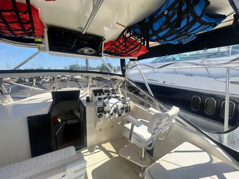 Slide: The Image of Interior of a 2004 Carolina Classic 28 boat, featuring helm and seating area. - 13