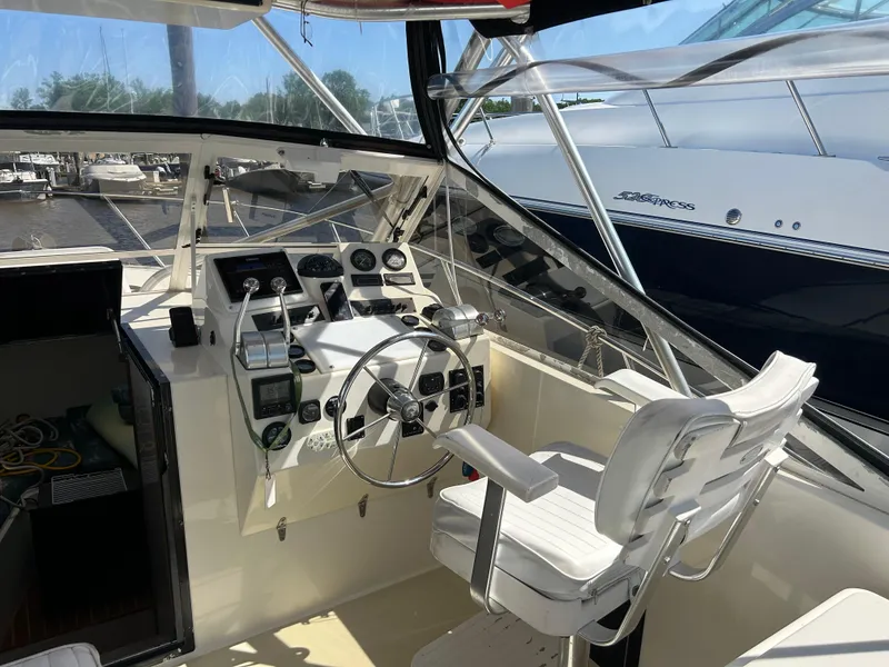 Slide: The Image of 2004 Carolina Classic 28 boat cockpit with steering wheel and control panel. - 14