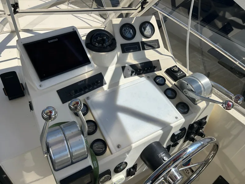 Slide: The Image of Control panel of a 2004 Carolina Classic 28 boat with navigation instruments. - 15