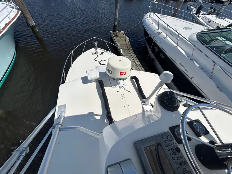 Slide: The Image of 2004 Carolina Classic 28 boat docked, featuring navigation equipment and radar system. - 23