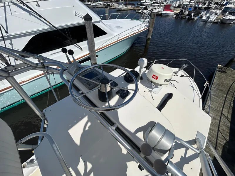 Slide: The Image of 2004 Carolina Classic 28 boat helm with navigation equipment at marina dock. - 25