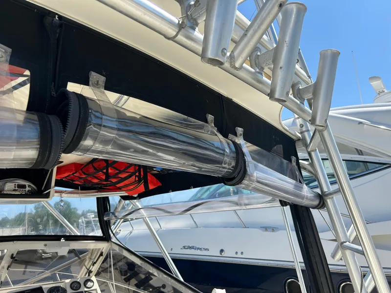 Slide: The Image of 2004 Carolina Classic 28 boat with rod holders and clear storage tubes on deck. - 29