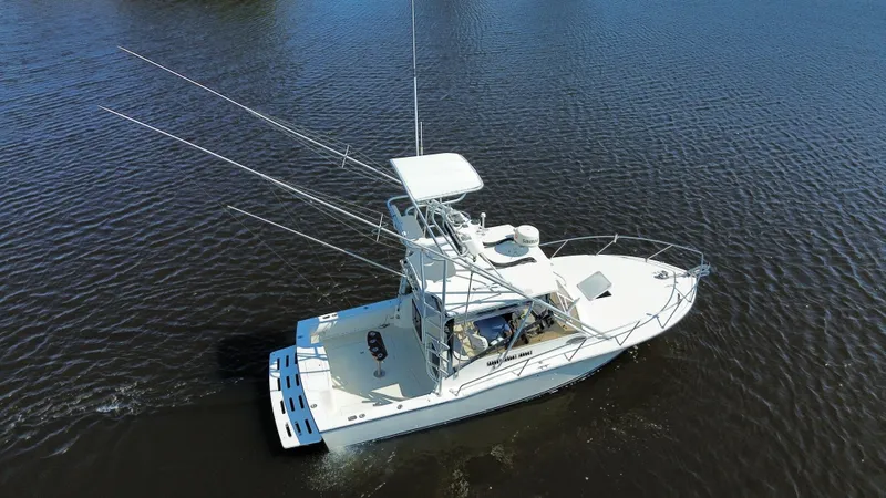Slide: The Image of 2004 Carolina Classic 28 boat cruising on calm water, aerial view. - 9