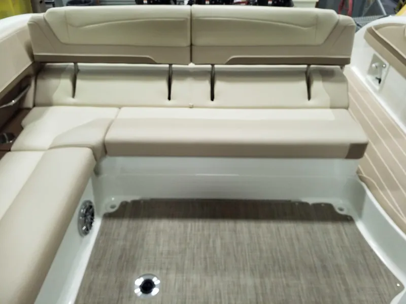 Slide: The Image of 2019 Formula 350 Crossover Bowrider OB interior with beige seating and carpeted flooring. - 10