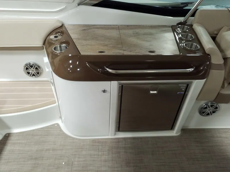 Slide: The Image of 2019 Formula 350 Crossover Bowrider OB interior with sleek kitchenette and cup holders. - 13