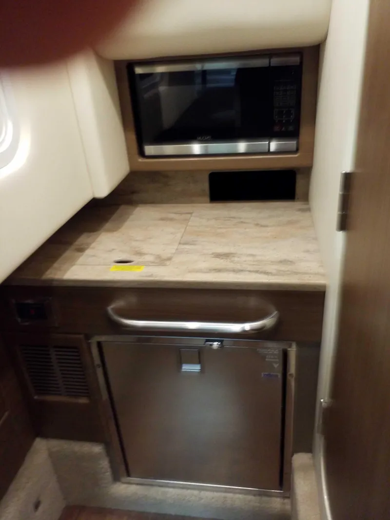 Slide: The Image of 2019 Formula 350 Crossover Bowrider OB interior kitchenette with microwave and mini-fridge. - 15