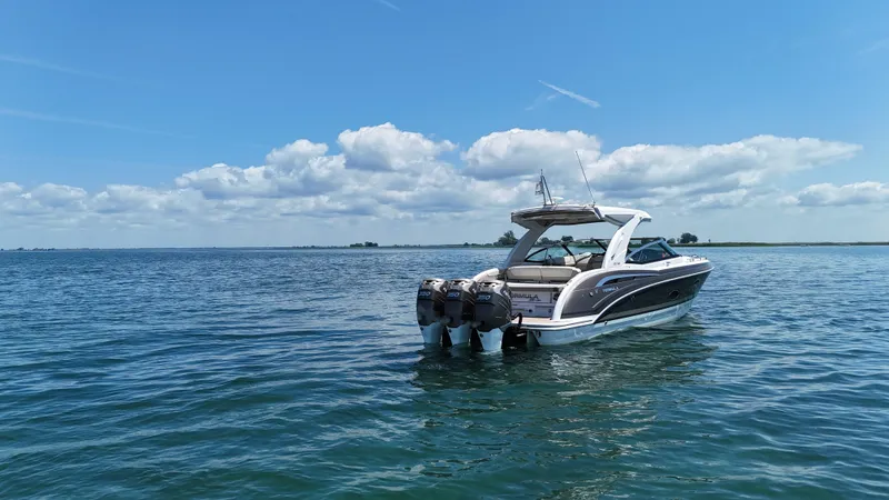 Slide: The Image of 2019 Formula 350 Crossover Bowrider OB on calm water under blue sky. - 2