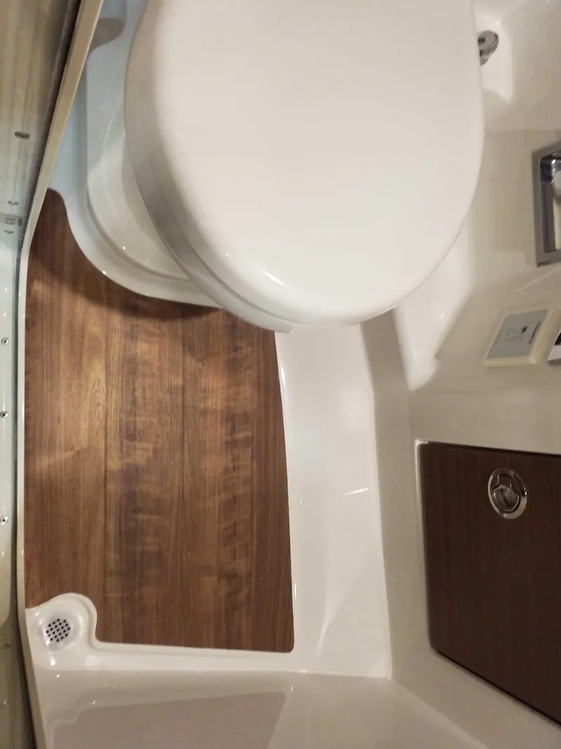 Slide: The Image of 2019 Formula 350 Crossover Bowrider OB bathroom with wooden flooring and modern fixtures. - 22