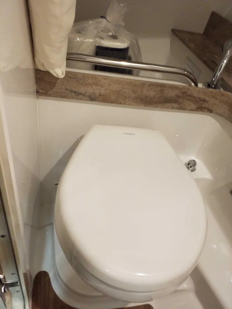 Slide: The Image of 2019 Formula 350 Crossover Bowrider OB bathroom with modern toilet and countertop. - 24
