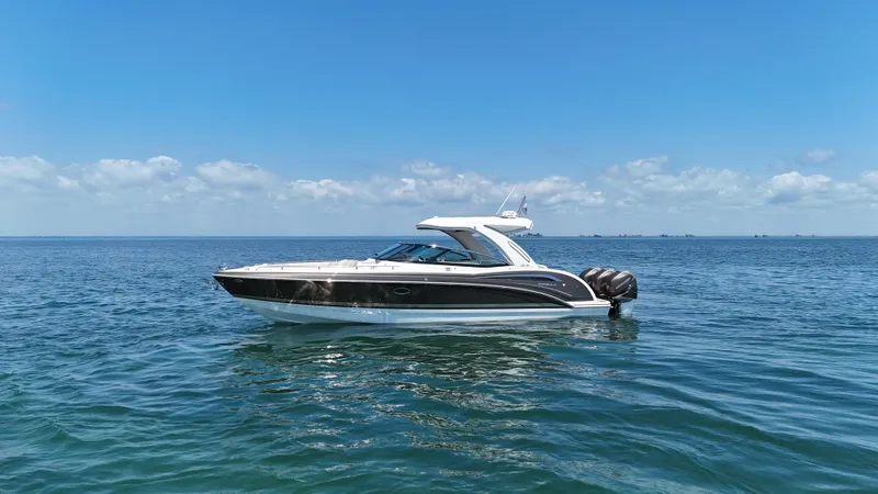 Slide: The Image of 2019 Formula 350 Crossover Bowrider OB on open water under clear blue sky. - 36