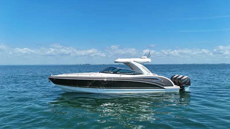Slide: The Image of 2019 Formula 350 Crossover Bowrider OB on open water under clear blue sky. - 37