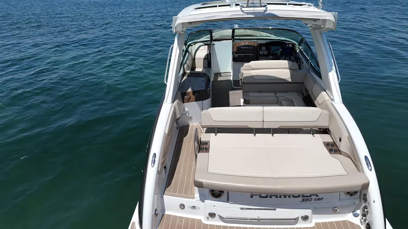 Slide: The Image of 2019 Formula 350 Crossover Bowrider OB on calm water, showcasing spacious seating and sleek design. - 46
