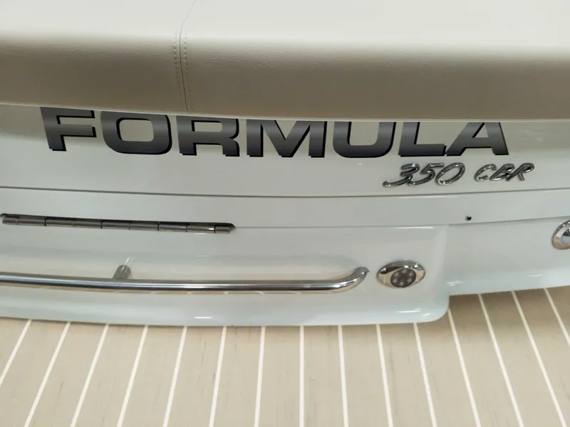 Slide: The Image of 2019 Formula 350 Crossover Bowrider OB boat rear view with logo and chrome details. - 8